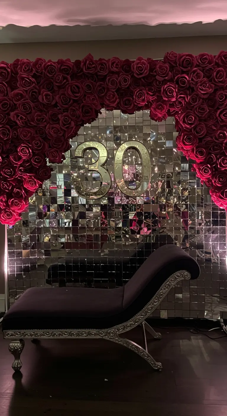 A mirror tile wall framed by red roses with