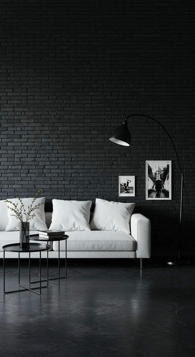 A crisp white sofa and black arc lamp set against a matte black painted brick wall.