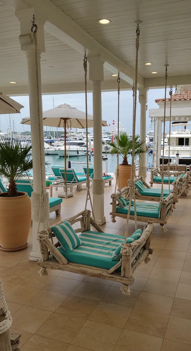 Several driftwood swing benches with aqua striped cushions on a marina deck.