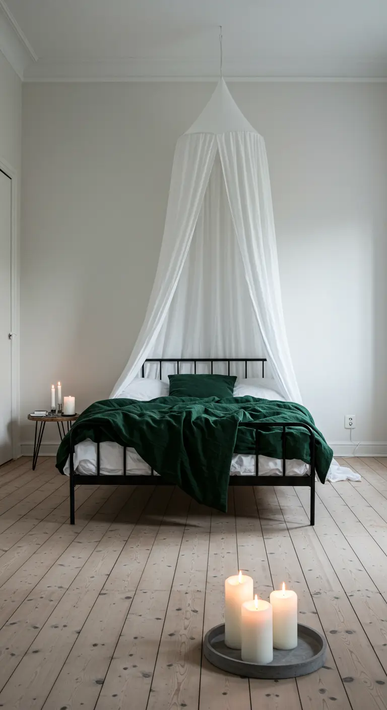 Minimalist bedroom with a black metal bed, white canopy, and dark green bedding.