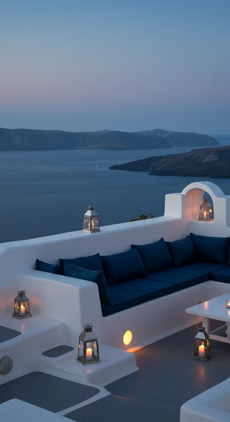 Whitewashed Santorini terrace with built-in seating and deep blue cushions.